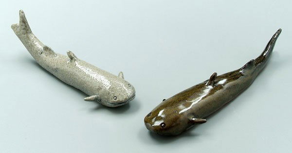 Two Charles Moore pottery catfish: one gray, stamped "1993", 7 in.; one green, stamped "1992", 8 in., [slight firing crack in base], both stamped "Jigtown Ware" and signed “Charles Moore”. Provenance: Private Collection.