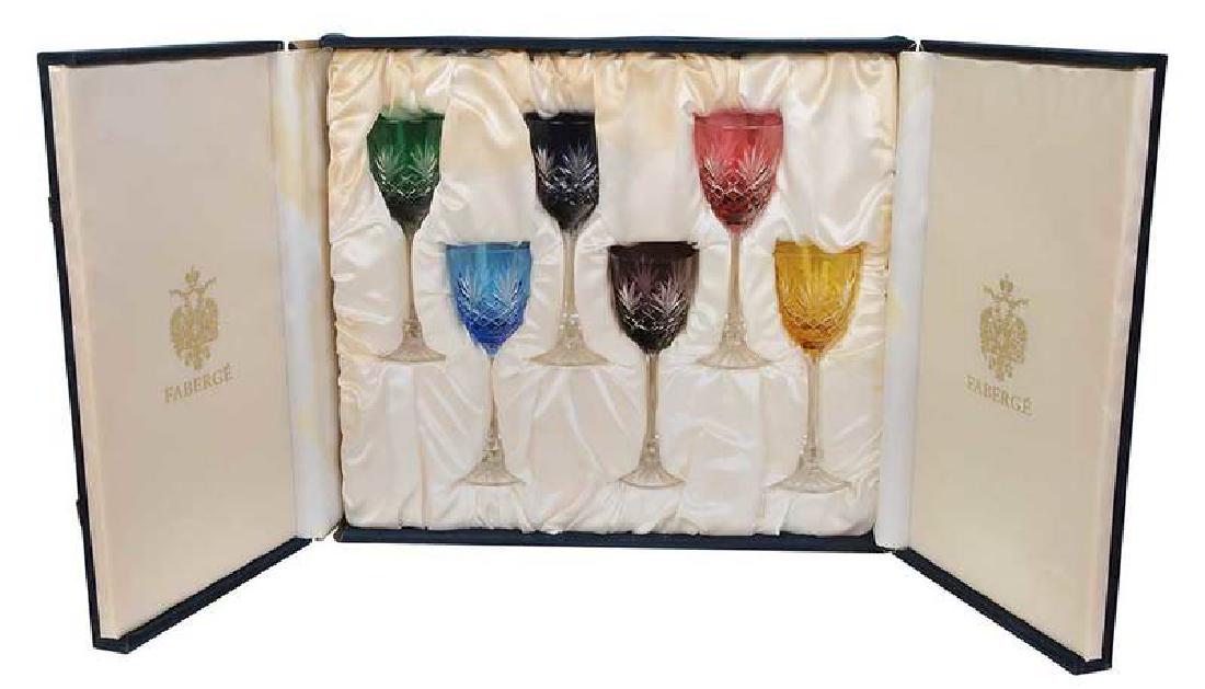 Six Faberge Wine Glasses in Case: 20th century, six cut to clear glasses in various jeweled colors, marked "Faberge" on base, in original blue velvet, satin lined fitted case, 8-1/2 in. Provenance: Private Collection