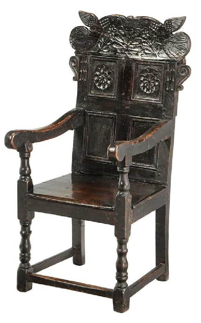 British Carved Oak Great Chair: 17th century elements, plank seat, carved back rest with floral and animal designs, 47 x 24 x 24 in. 