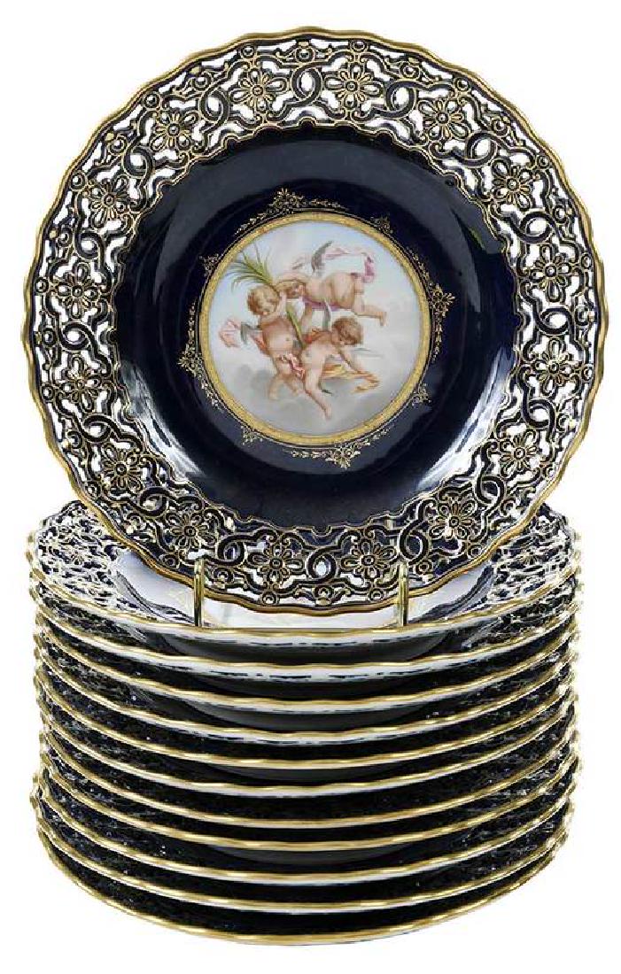 12 Meissen Hand Painted Plates with Cherubs: German, 19th century, wells with hand painted scenes of cherubs and putti bordered by cobalt ground and gilt decorated reticulated rims, underglazed blue crossed swords mark, 9-1/4 in.