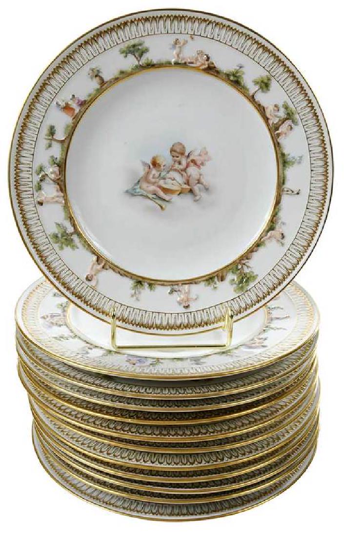 Set of 12 Meissen Porcelain Plates with Cherubs: German, 19th century, hand painted scenes of cherubs in centers bordered by raised classical decoration and gilt accents, underglazed blue crossed swords mark, several plates with old label for "Gilmo