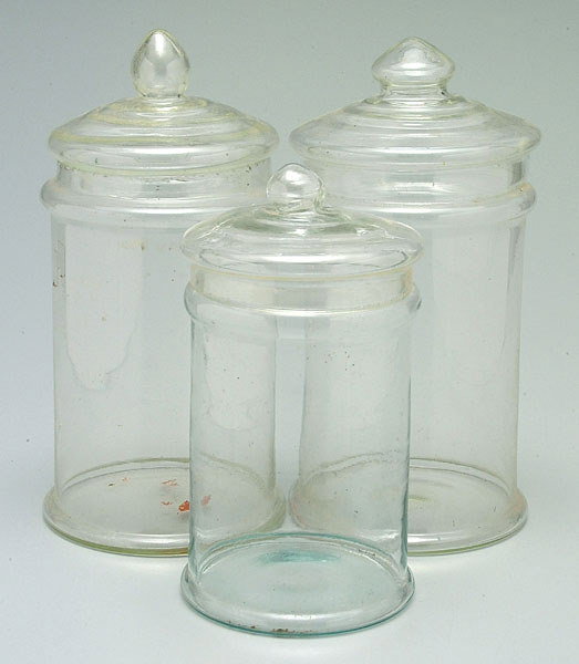 Three glass lidded canisters: