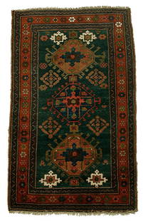 Hand-woven Kazak style rug,: three central medallions with hooks on blue field, brick red, blue and brown borders, generally even medium pile, slight wear and corrosion, 4'6" x 6'11"