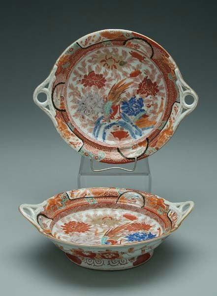 Pair Japanese Imari footed dishes: looped handles and molded flowers on rim, interior with phoenix and peonies, exterior with iron red flowering vines, iron red six-character mark on base and old Michael Davis shipping label, early 20t