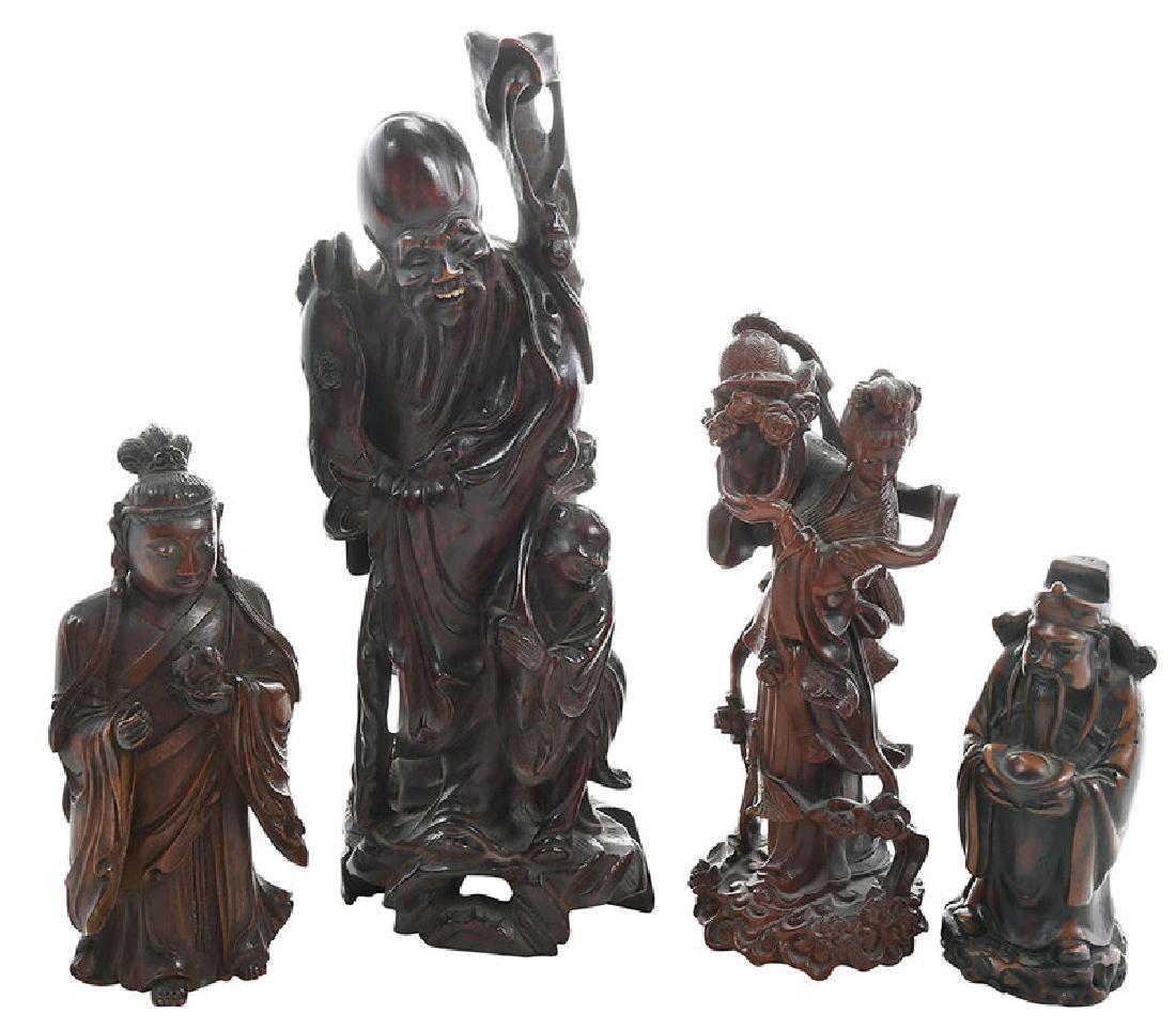 Four Asian Carved Figurines: 19th/20th century, comprising three wood, one bone: an old man with attendant, with large head, bone teeth, 11-1/2 x 4-1/2 in.; Lan Ts'ai-ho turning a basket of flowers, with glass eyes, 8-1/4 x 3 in.