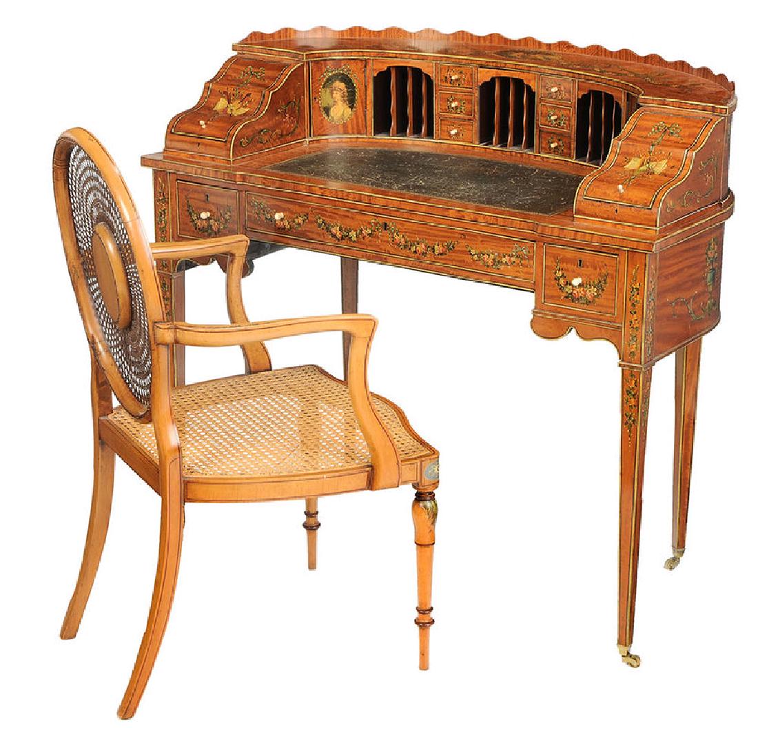 An Edwardian Adam Style Carlton House Desk, Chair: British, circa 1900, fine quality, with highly figured satinwood, hand painted garlands and medallions, fully finished back, dovetailed drawers with bone pulls, with a related caned open armchair, 38-
