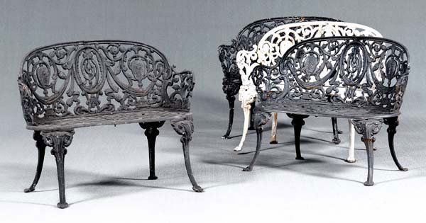 Set of four cast iron garden settees: each with pierced urn and vine decorated back, scrolled seats and legs, three black painted and one white, probably early 20th century, 30-1/2 x 37 x 13-1/2 in. (seat). One with weld repairs to rear l