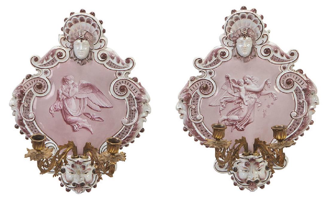 Pair Italian Majolica Wall Sconces: Continental, 20th century, shield form with hand painted interior classical scenes, scrolled border, head and shell crest, grotesque masks at sides and bottom, two attachable scrolled brass arms issue