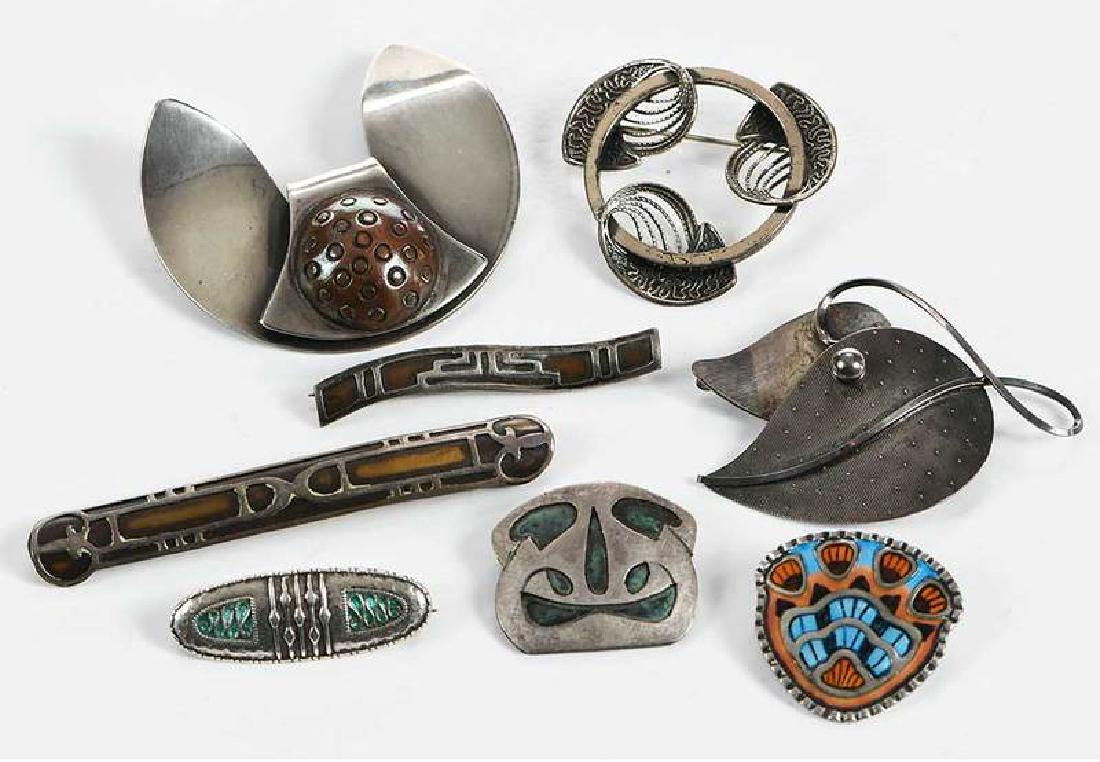 Eight Brooches: one Sam Kramer "Ear Pin", five assorted sterling pins, two copper and silver pins, 1/2 x 1-3/8 to 1-3/4 x 2 in., 61.8 grams Provenance: Estate of Merianne Miller