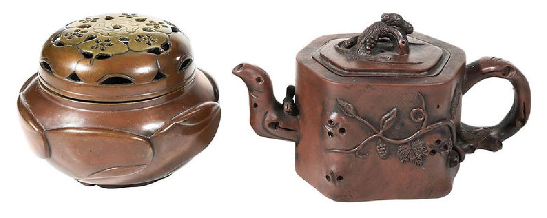 Chinese Yixing Teapot and Bronze Koro Censer: Qing dynasty, richly patinated bronze censer with whirling decoration and pierced lid; Yixing teapot with grapevine decoration, bixie finial on lid, with marks, 4 in. Provenance: Private Collection