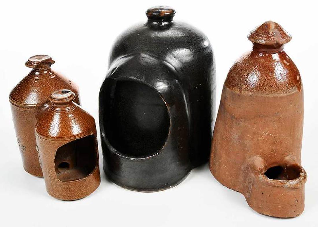 Three Ceramic Chicken Waterers: American, late 19th, early 20th century, stoneware Albany slip with knob finial; stoneware, double knobs, brown glaze, redware, partially glazed, 7 in. to 10 in. Provenance: Private Williamsburg, Virg