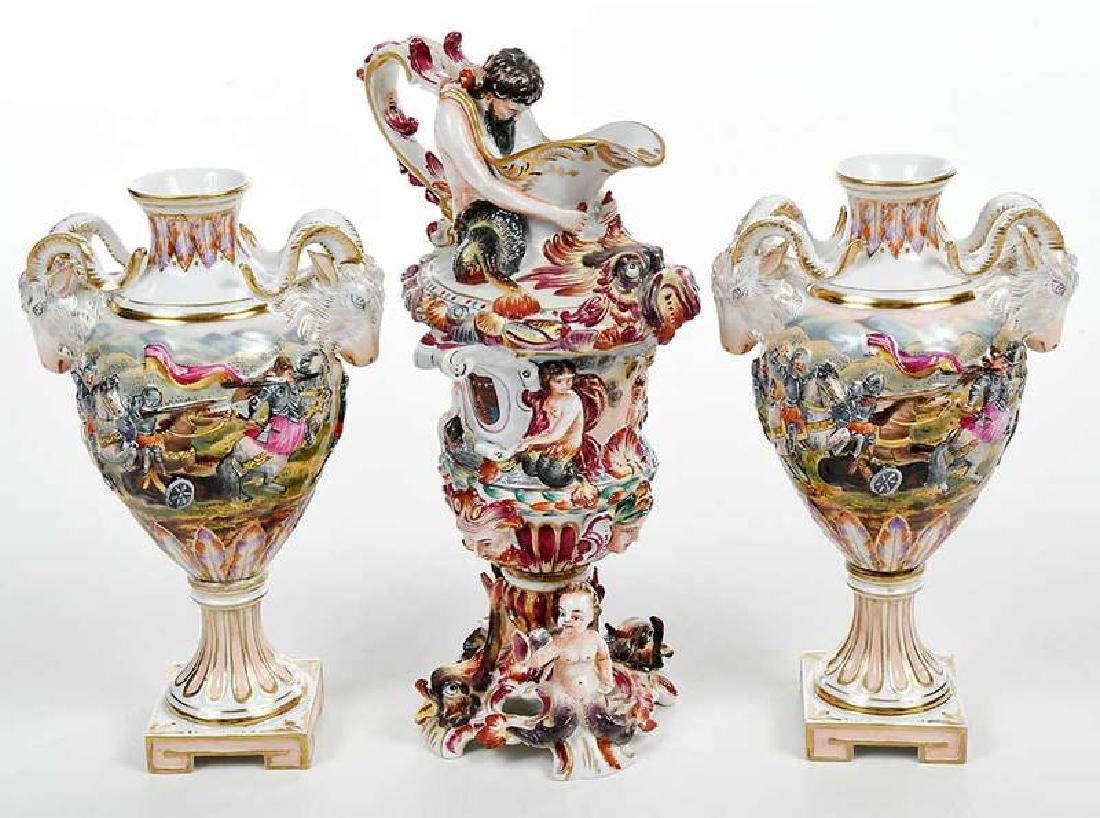 Three Pieces Capodimonte Porcelain: Italian, late 19th century, small ewer with mythological sea creatures, 8-1/2 in.; together with pair of urns decorated with battle scenes, all with "N" under crown mark, 7-1/2 in. Provenance: Private