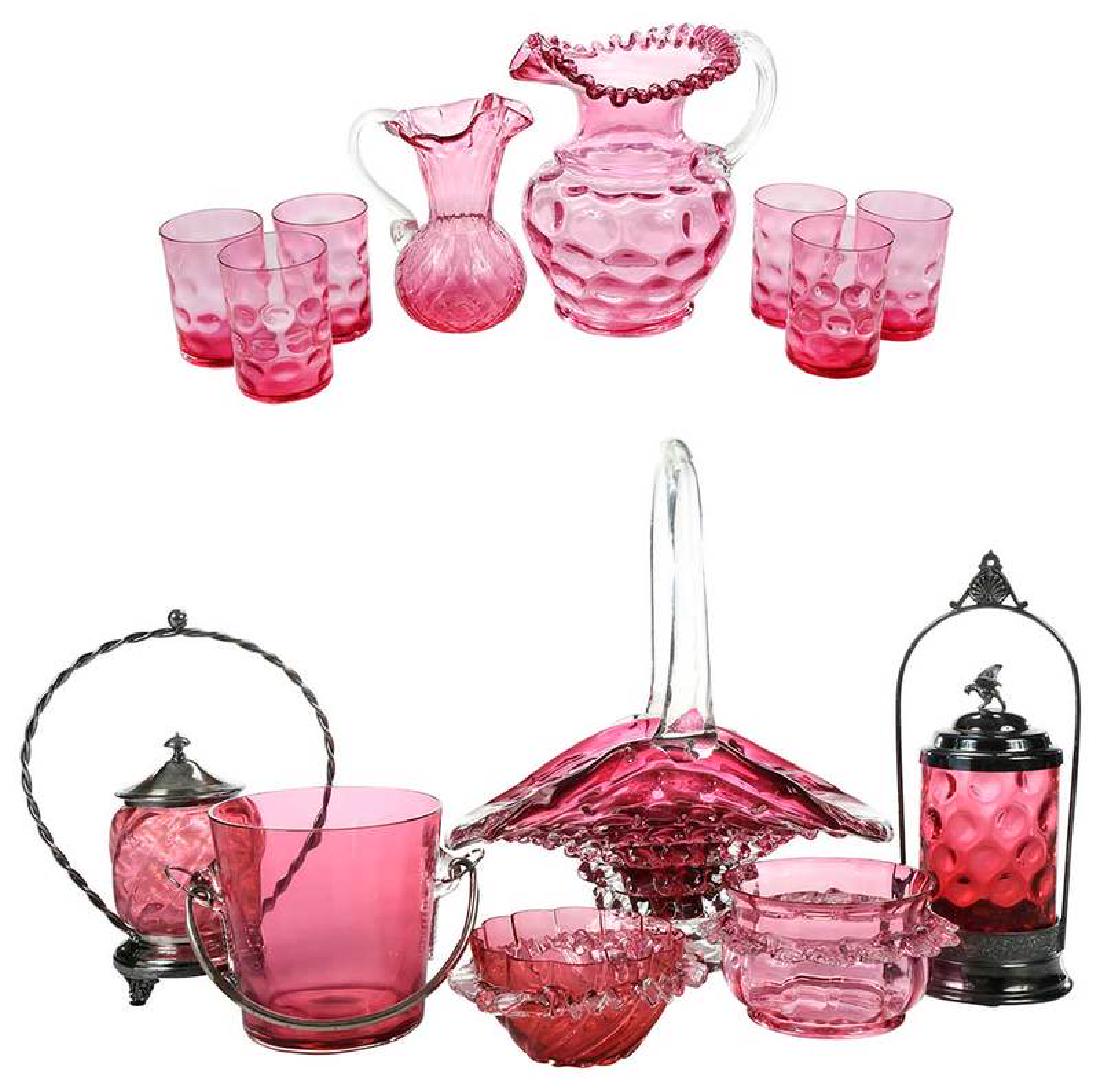 Fourteen Pieces Hand Blown Cranberry Glass: 20th century, comprising: hobnail pitcher, ruffled spout, clear handle, 8-3/4 in.; six hobnail tumblers, 3-15/16 in.; ice bucket, feathered hoops and metal hardware, 5-1/4 in.; mini pitcher with ruffl