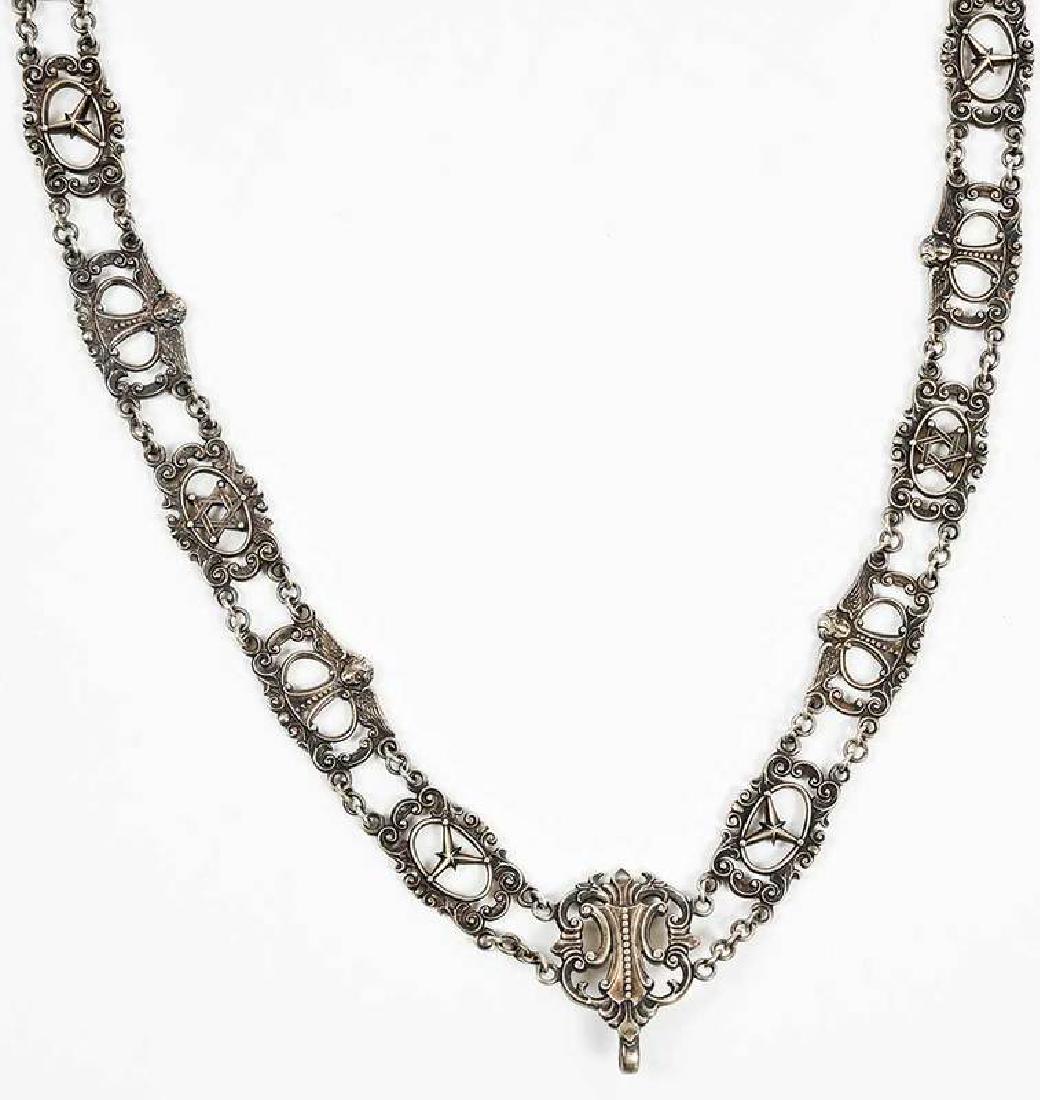 Silver Regalia Chain: Birmingham, 1955, alternating scroll panels with winged cupids and stars, central scroll and foliate panel with hook, marks for Mappin & Webb Ltd., .925 fine, 6.92 oz. T., 23 in. long Provenance: