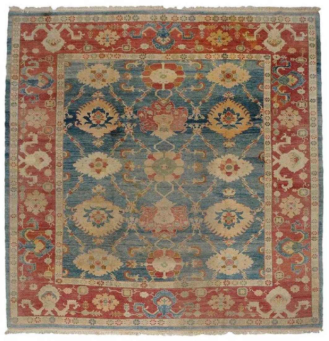 Mahal Carpet: mid/late 20th century, rows of medallions on blue ground, pale red major border, ivory and green highlights, 12 ft. 5 in. x 13 ft. 6 in. Provenance: Collection of Marion and Theodore Gore, Williamsbur