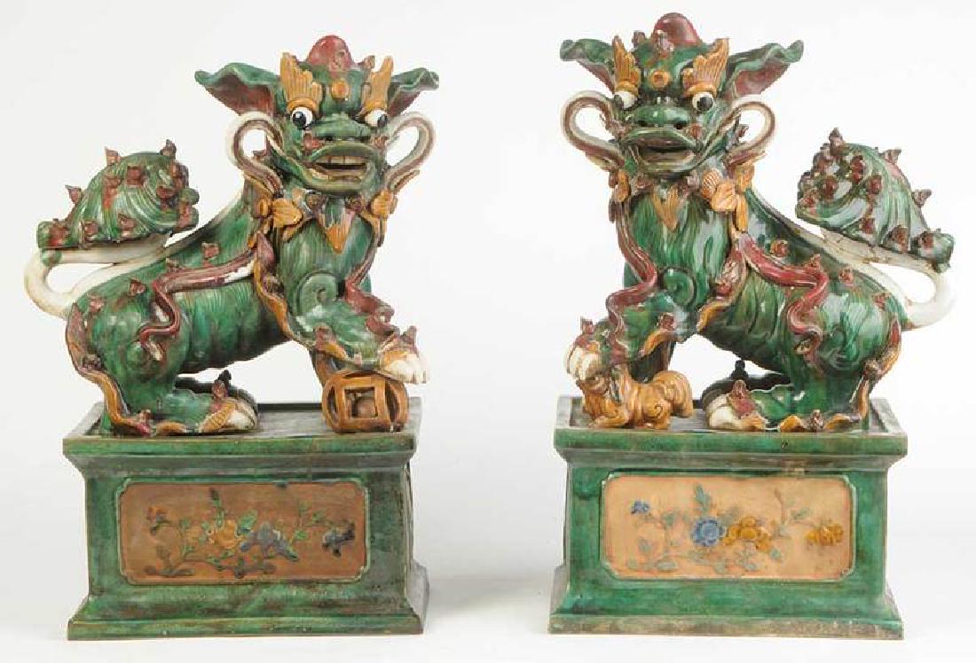 Large Pair Chinese Ceramic Foo Dogs: 20th century, each set on a plinth with prunus branch decoration, 27-1/2 in. Provenance: Private Collection