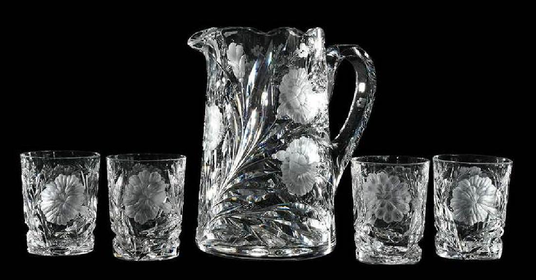 Cut Glass Hawkes Pitcher, Four Tumblers: "Gravic Carnation" pattern, all but one tumbler with Hawkes mark, 3-1/2 in. tumblers, 8-1/2 in. pitcher Provenance: The Collection of Leon "Chink" Weinstein