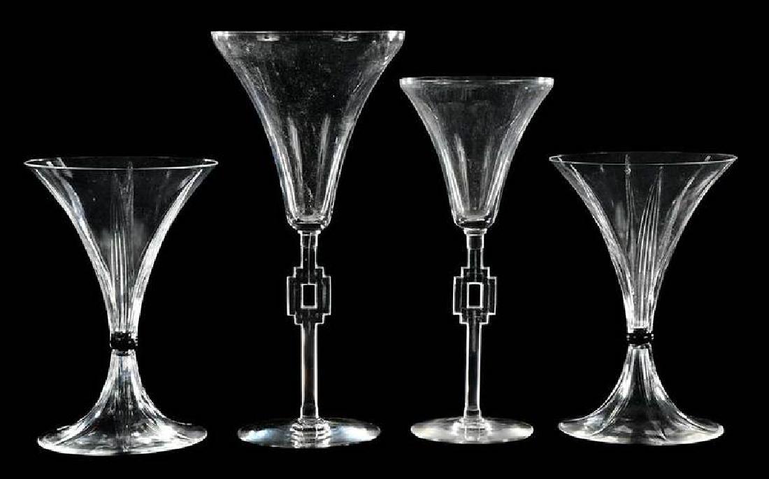 Two Pairs Lalique Deco Champagne Stems: pair "Selestat" trumpet flutes, black bead in center, signed "R. Lalique France N5074", 5-1/2 in.; pair "Hagananaur" flutes, signed "R.Lalique", 8 in. and 7-1/4 in. 