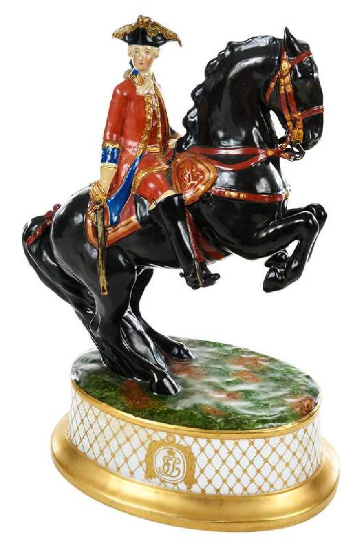 Russian Imperial Porcelain Factory Figurine: Saint Petersburg, circa 1902, marked at base "[Tsar Nicholas II cypher]/1902 (?)", parcel-gilt and polychrome decorated, depicting a military leader on a rearing horse with Romanov imperial cypher at 