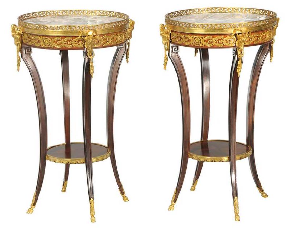 Pair Louis XVI Style Bronze-Mounted Guéridons: French, late 20th century, each mahogany with circular marble top, gilt bronze mounted frieze set with goat's headed handles, bronze hoofed feet, 32 x 17-3/4 in. Provenance: Property From an Important