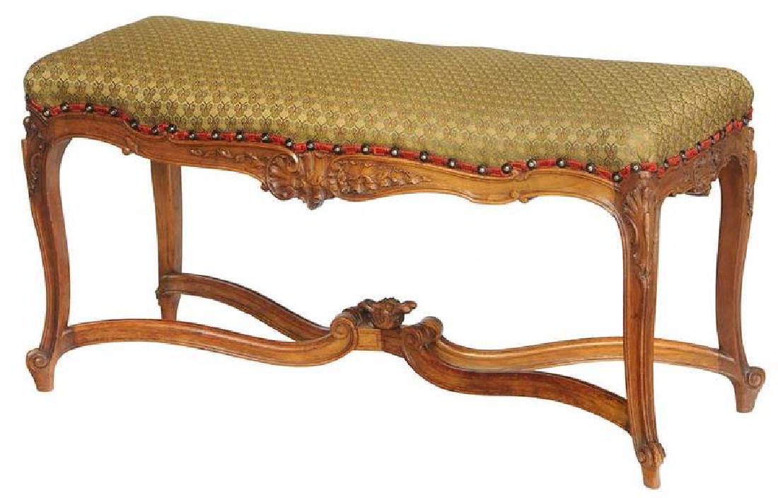 Provincial Louis XV Style Carved Walnut Bench: French, early 20th century, well-carved frame set with green silk upholstery on a cross stretcher base, 20 x 38-1/2 x 16-1/2 in. Provenance: Property From an Important Tennessee Living Estate