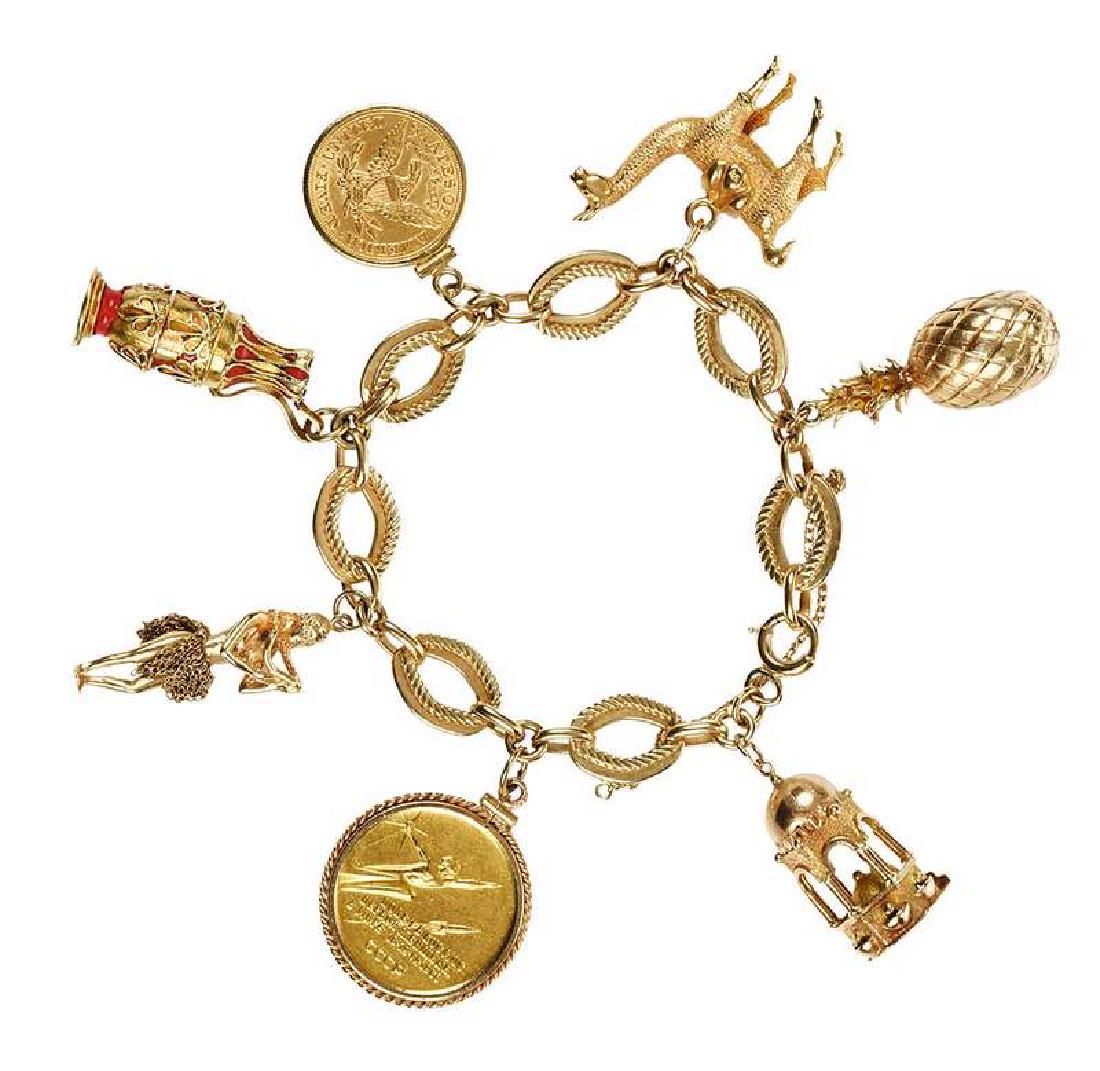 Gold Charm Bracelet: five 14kt. charms including: coin, pineapple, urn and hula dancer, two 18kt. charms: camel and coin, chain stamped "14Kt", yellow gold, 7 in. lg., 89.4 grams Provenance: Collection of James B. MacNeil