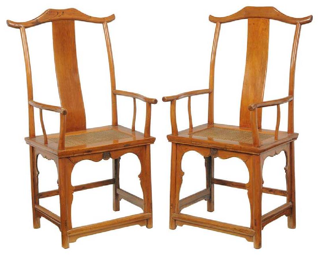 Pair Chinese Elm Oxbow Arm Chairs: Qing dynasty, each elm throughout with woven cane seat, one with calligraphic inscription under seat, 47-1/2 in.