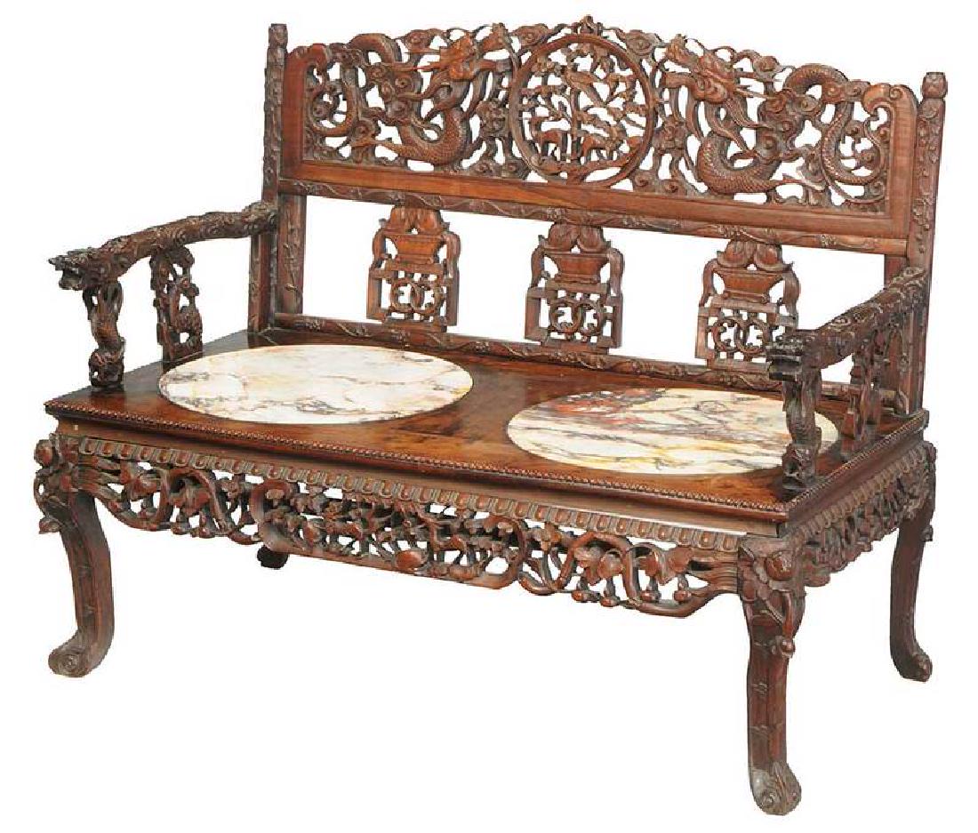 Chinese Carved Hardwood Marble-Inset Settee: late Qing dynasty, figured hardwood (rosewood and possibly huanghuali), dragon-carved back and arms, seat set with two circular marble insets, 40-1/2 x 50 x 27 in. Provenance: Private Collection,