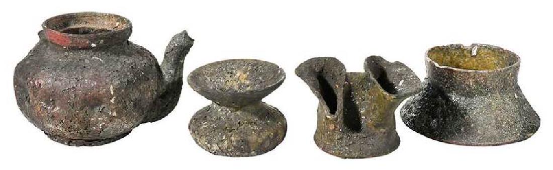 Four George Ohr Burnt Babies: American, 20th century, all pieces with impressed mark "George Ohr/Biloxi", tea pot with dimpled sides, 3 x 5 in.; small vase with wide flaring base, straight rim, 2 x 4-1/4 in.; small dimp