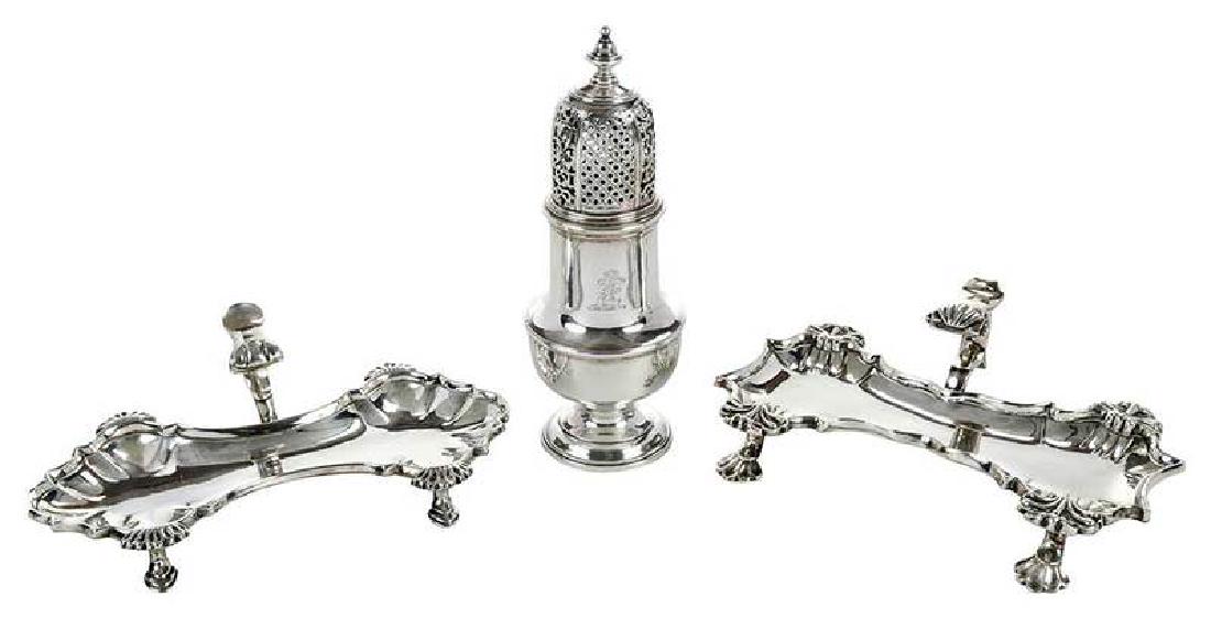 English Silver Caster, Two Snuffer Stands: including a pair cartouche form snuff trays with shell decoration, no monogram, marks for London, John Cafe, possibly 1741, 2-1/4 x 7-1/4 x 4-1/2 in.; urn form caster, heraldic device, marks for Londo