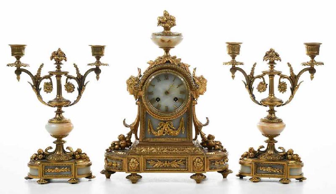 Second Empire Ormolu and Onyx Clock Garniture: French, mid/late 19th century, onyx face with gilt Roman numerals, eight day brass time and strike movement, mark for Japy Frères, 14-1/2 x 11-1/2 x 5 in.; pair two branch candelabra, 11-1