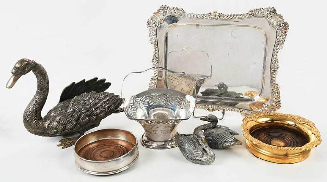 Seven Silver Table Items: English silver coaster, 20th century, London, 5 in.; sterling basket, marks Bailey Banks & Biddle, 7.02 oz. T., 6-3/4 x 6 in.; gilt metal coaster; three white metal swans; old Sheffield plate entree i