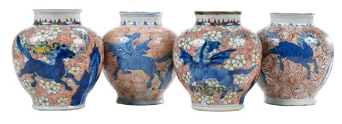Four Chinese Dragon Horse Vases: Qing dynasty, similar design of blue horses on one side and dragon horses longmas verso, amidst prunus blossoms, rock work, and ribbons on iron red spiral ground, 5-1/2 in. , Provenance: Es