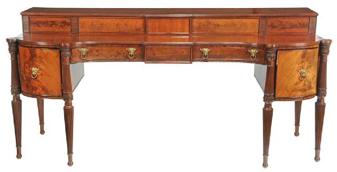 Fine Regency Style Carved Mahogany Sideboard: British, 19th century, stepped top with sliding doors over three central drawers flanked by cellaret drawer and door, ram's headed brasses, 43-1/2 x 95 x 34 in., Provenance: Estate of Danny Wigin