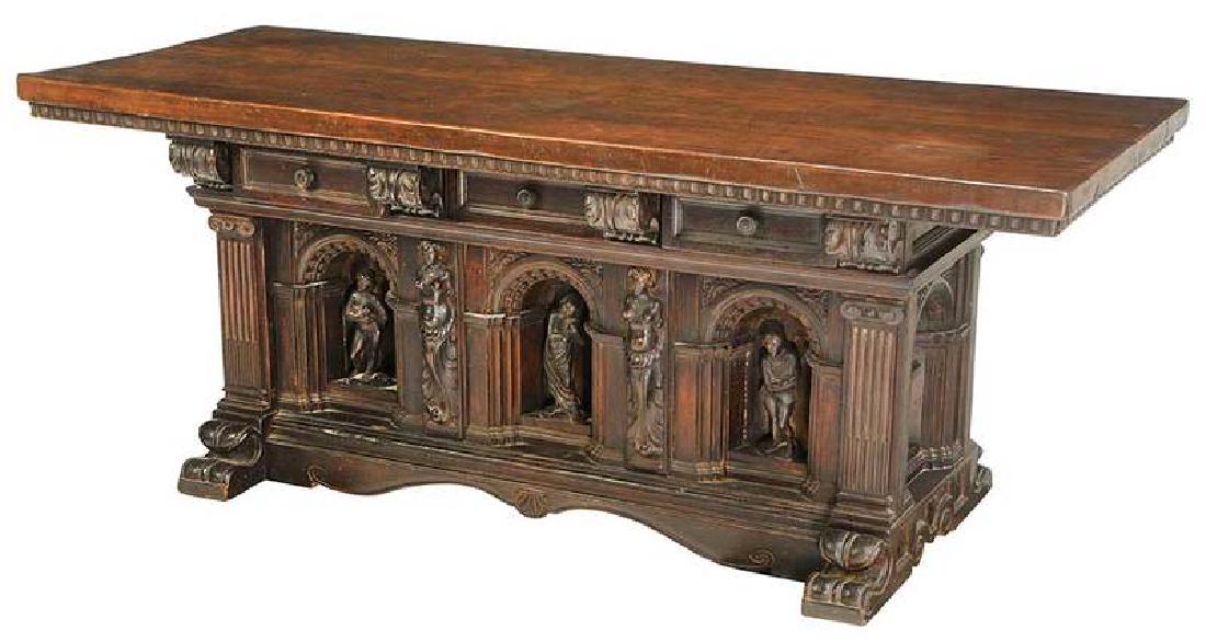 Italian Renaissance Style Carved Library Table: 20th century with some earlier elements, heavy walnut top, three dovetailed drawers, arcaded base with inset niches, each with figural carving, set on scrolled feet, 31 x 79 x 31 in., Provenance: Priv