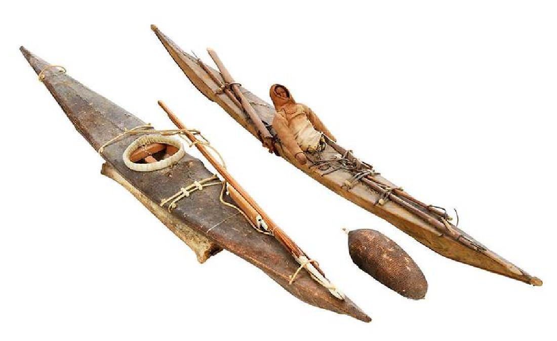 Two Inuit Kayak Models: 19th/20th century, model with carved wood figure, cloth clothing, bone and leather hunting implements including harpoon and leather/hide float, stretched hide/leather kayak, bone stand, 22 in.; stretc