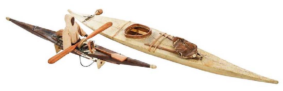 Two Inuit Kayak Models: 19th/20th century, carved wood figure and assorted hunting implements, bone, hide/skin, 22 in.; model with no figure, wood, hide/skin, 29 in. , Provenance: Estate of Charlie Tate, Asheville, Nort