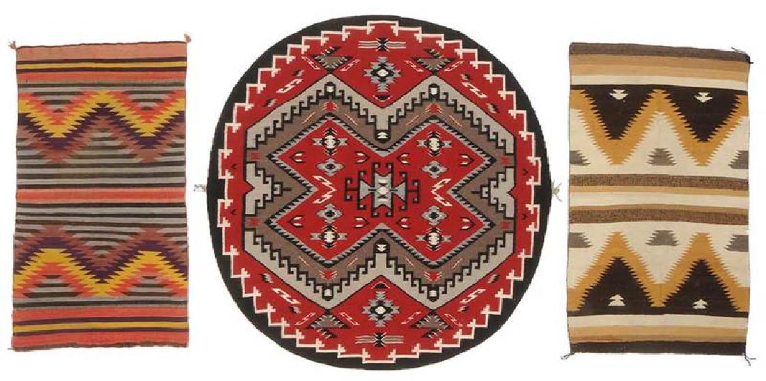 Three Navajo Weavings: late 19th/early 20th century, two Eye Dazzler saddle blankets:; one brightly colored stripes and stepped zigzag pattern, 54 x 34 in.; one in tones of ocher and browns, 50 x 28 in.; mid 20th cent