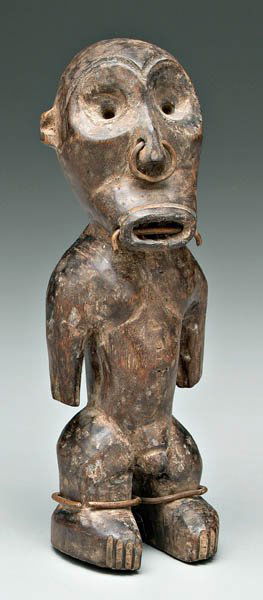 African carved wood male figure,: standing man with copper wire in nose, mouth, on ankle and lip rings, possibly Azande-Ngbake (Equatorial Forest area), 8-1/2 in. Old uncleaned surface with mellow patination, minor surface flaws and s