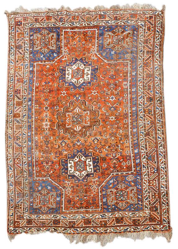 Caucasian Carpet: early to mid-20th century, three medallions on rust ground, similar motifs in corners, borders with quadrupeds, ivory, green, and royal blue highlights, 7 ft. 2 in. x 10 ft. 1 in.