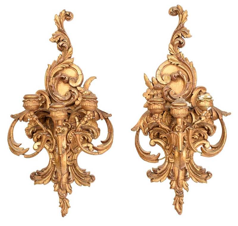 Pair Gilt Three Arm Wall Sconces: 19th/20th century, gilded composition with foliate and floral motif, scrolling arms and candle cups, hanging attachments on undersides, 20 in. Provenance: A Private South Carolina Collection