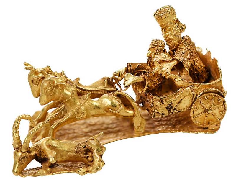 21kt. Hunting Scene Sculpture: Persian-style small sculpture depicting hunter with bow and arrow riding chariot and hunting an ibex, x-ray tested 21kt. yellow gold, "MNP.70.31" written in red on underside- spurious museum markings,