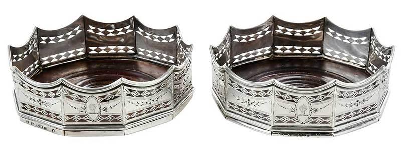 Pair of English Silver Wine Coasters in Box: London, 1788, openwork engraved sides, wooden bases, maker possibly Benjamin Mountigue, each 1-1/4 x 4-3/4 x 4-3/4 in.; with later wood case Provenance: Private Collection, Hilton Head, South Carolina