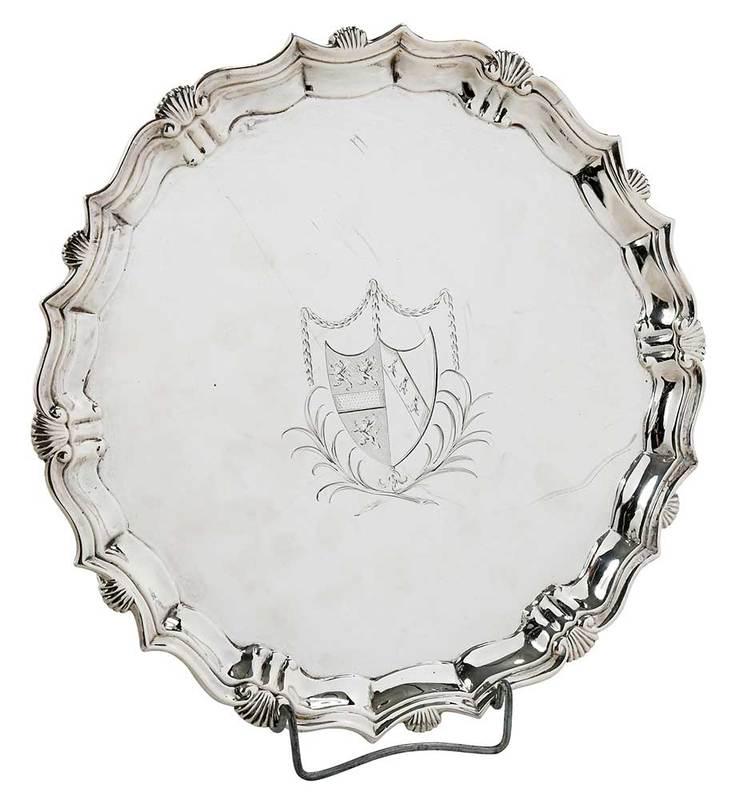 George II English Silver Salver: London, 1739, scroll and shell border, three scroll fee,ÿcentral heraldic device with swags and foliate decoration, marks for John Tuite, 14.98 oz. T., 9-1/4 in.; Provenance: I. Freeman & Son, New Yo