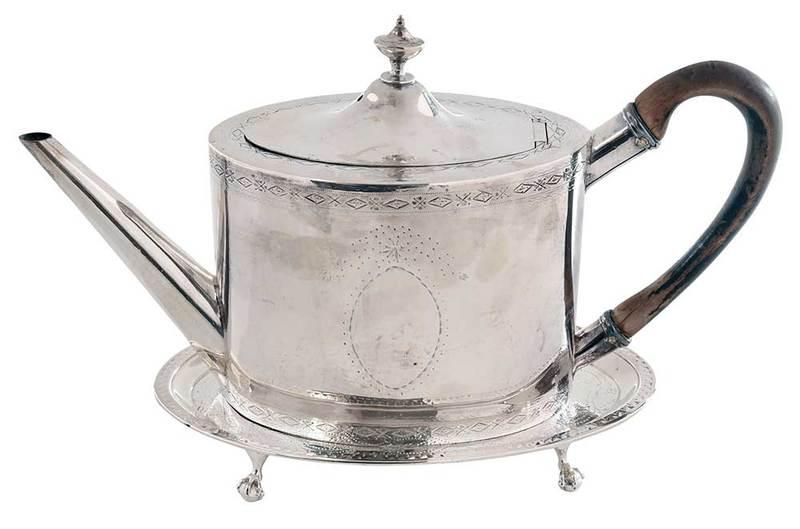 George III English Silver Teapot and Tray: London, both oval with engraved decoration, no monograms: teapot with wooden handle, marks for 1785, partial maker's mark, 5-1/2 x 10-1/4 x 3-1/2 in.; tray with paw feet, marks for 1785, partial maker