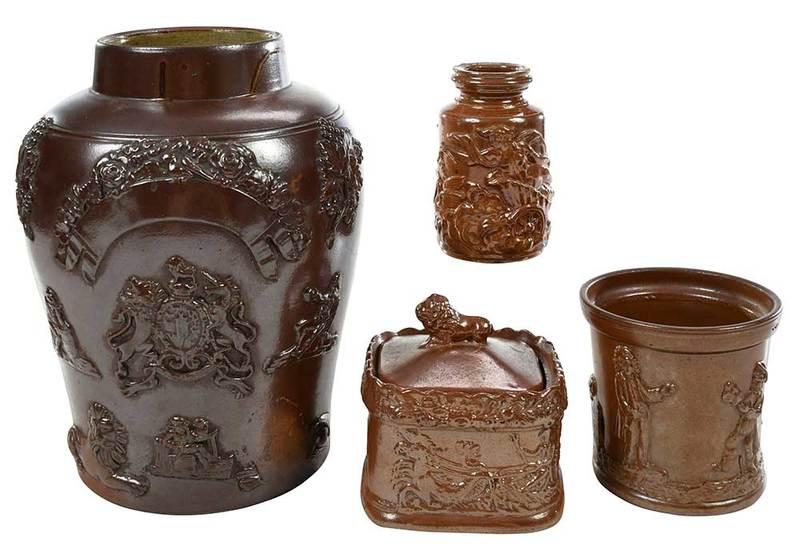 Four Sprig Decorated Stoneware Table Items: British, 19th century, large brown glazed jar with Royal Coat of Arms, auction label on side, "Michael Davis/ for Avalon Antiques; lidded box with lion finial and classical figures; bottle with classi