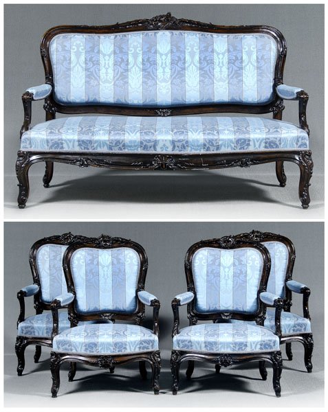 Louis XV style five-piece salon suite: comprising a settee and four armchairs, each with carved crest and arm supports, shell-carved skirts on carved legs, fine blue striped silk upholstery, French, probably late 19th century, settee 43 x