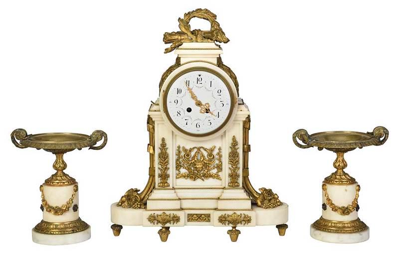 Louis XVI Style Marble Clock and Garniture Set: French, mid 19th century, white marble rectangular case with gilt bronze mountings of bead borders, flowers, and floral elements intertwining a mask, hunt trophy finial, enamel dial with Arabic numera