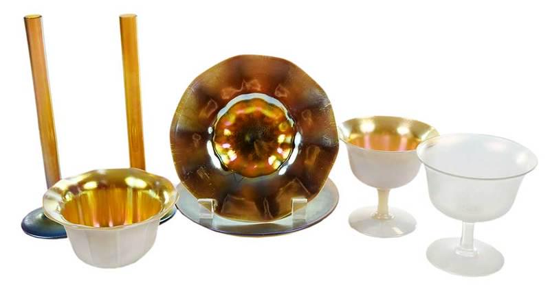 Eight Pieces Steuben Aurene Glass: American, early 20th century, four unsigned pieces gold aurene and white calcite including sherbet, bowl, three plates; two stick vases, signed "Steuben Aurene 2556"; one opaque sherbet with monogram,