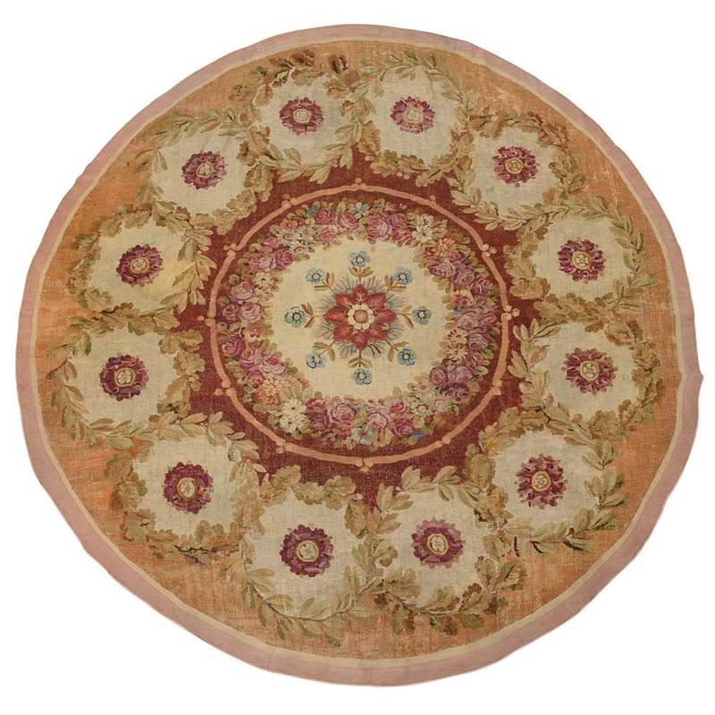 Round Aubusson Style Rug: Continental, 19th century, tapestry woven, central medallion with rose decoration, ringed by acanthus leaf panels with rose centers, later backing, 9 ft. 8 in. x 9 ft. 6-1/2 in., Provenance: Collectio